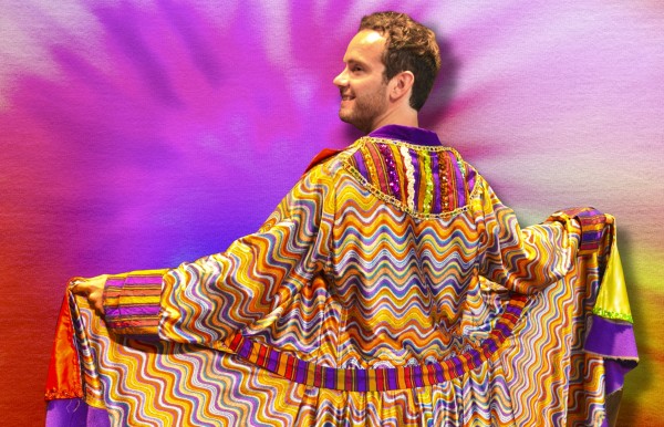 Matt Casey has returned to the Round Barn Theatre as Joseph in “Joseph and the Amazing Technicolor Dreamcoat. He is shown wearing the coat of many colors, a gift from his father. The show runs through Oct. 19.