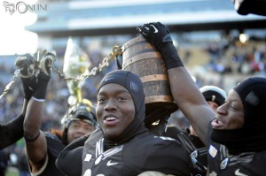 Members of the Purdue Boilermaker football team celebrate with the Old Oaken Bucket after beating Indiana 56-35 Saturday at Ross-Ade Stadium in West Lafayette. (Photos by Mike Deak)