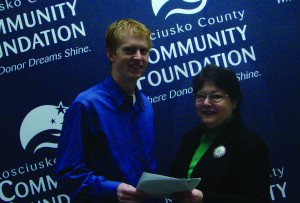 KLAS Director Dr. Nate Bosch, presents a signed fund agreement for the Kosciusko Lakes and Streams Endowment Fund to Suzie Light, executive director of the Kosciusko County Community Foundation.