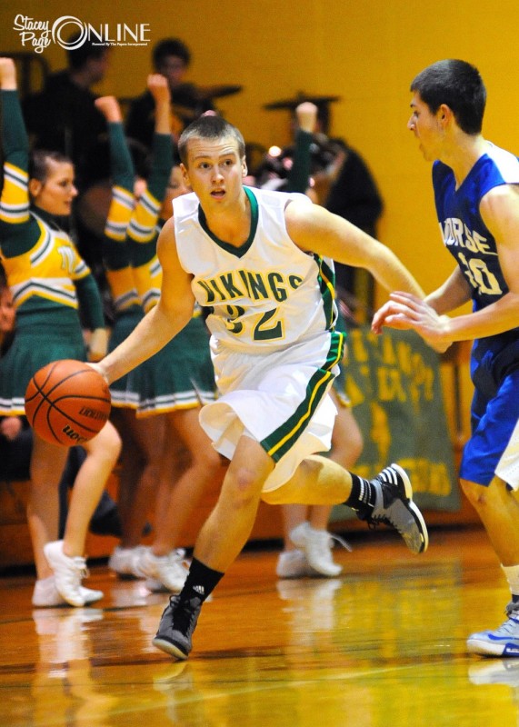 Senior Nick Kindig of Tippecanoe Valley drives past a Northfield defender Jan. 4. Kindig scored his 1,000th career point Friday night in a win at Rochester (Photo by Mike Deak)