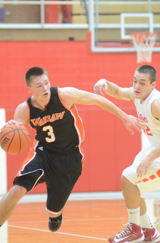 Jared Bloom heads to the hoop versus Plymouth Thursday night. The Warsaw senior had 11 points in a 57-56 loss in the NLC finale.