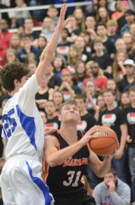 Taylor Cone works inside against the defense of AJ Glick of Adams on Saturday at Michigan City.