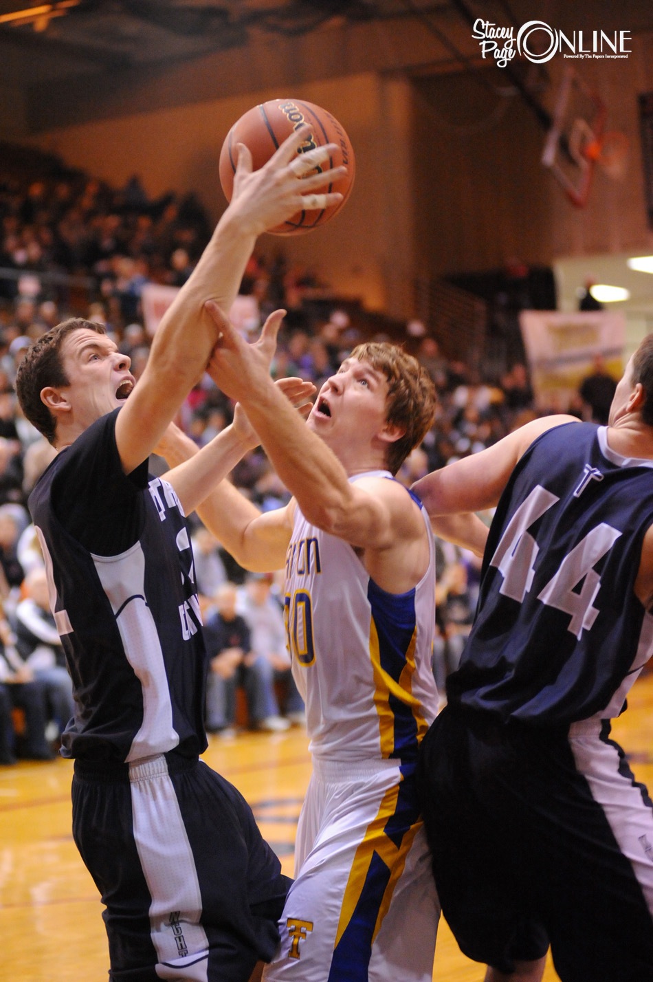 Triton senior Seth Glingle (center) tussles with a pair of players from Lafayette Central Catholic during semi state action last Saturday. Glingle and the Trojans play for a state championship Saturday in Indianapolis (Photo by Mike Deak)