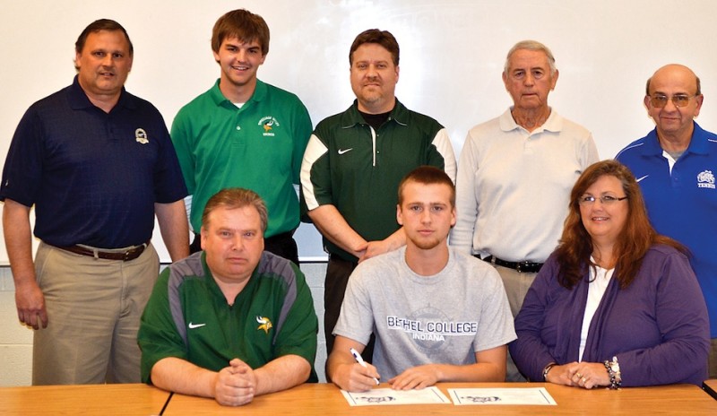 Tippecanoe Valley two-sport standout Nick Kindig signed recently with Bethel College. Kindig is shown above in the middle of the front row, flanked by his parent Chris and Sharon. In back (from left) are TVHS Athletic Director Duane Burkhart, Valley assistant tennis coach Rosten Hamman, Valley tennis coach Matt Mobley, Valley boys basketball coach Bill Patrick and Bethel College tennis coach John Natali (Photo provided)