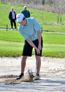 Chipping from the fifth bunker is Wawasee's Jeffrey Moore.