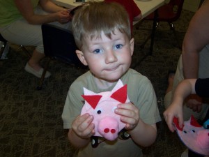  Kolbe Vint, Milford shows his piggy he made out of a cd.  He made it at story time at the Milford Public Library.  The theme for the day was Down on the Farm. (photo provided)