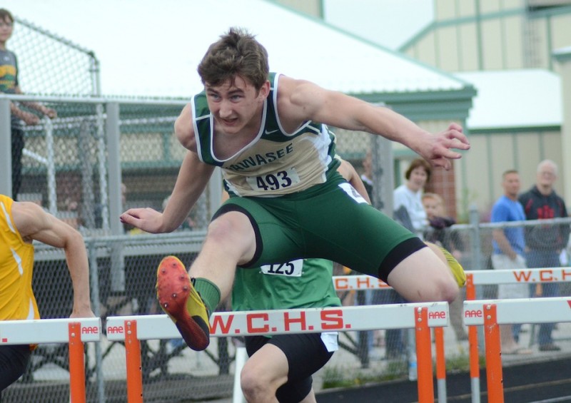 Wawasee's Clayton Cook soars to victory in the 110 hurdles at the NLC Meet Tuesday night in Warsaw. The stellar sophomore won both hurdles events (Photos by Jim Harris)