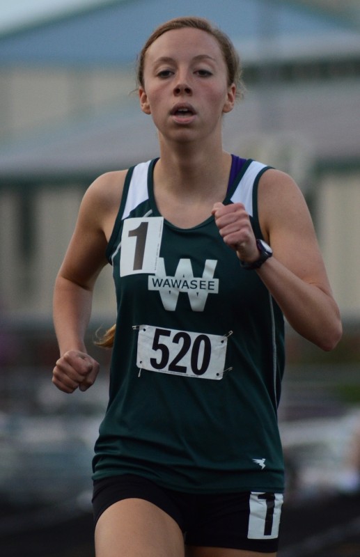 Senior Jen Slabaugh runs in the 1,600 for the Warriors at the NLC Meet Tuesday night.