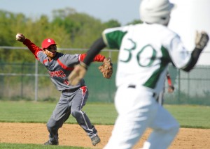 Goshen second baseman Jorge Pizana throws to first to get Wawasee's Nate Prescott out.