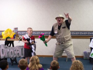 William Arford tries to wave different wands at the dinosaurologist to make the flowers appear.   (Photo provided) 