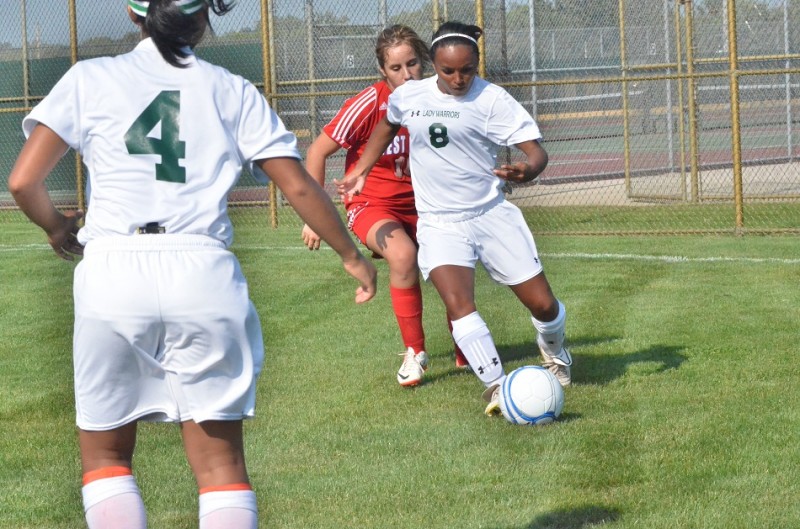 Breanna Ferm works around West Noble's Jocelyn Rivera Wednesday night.