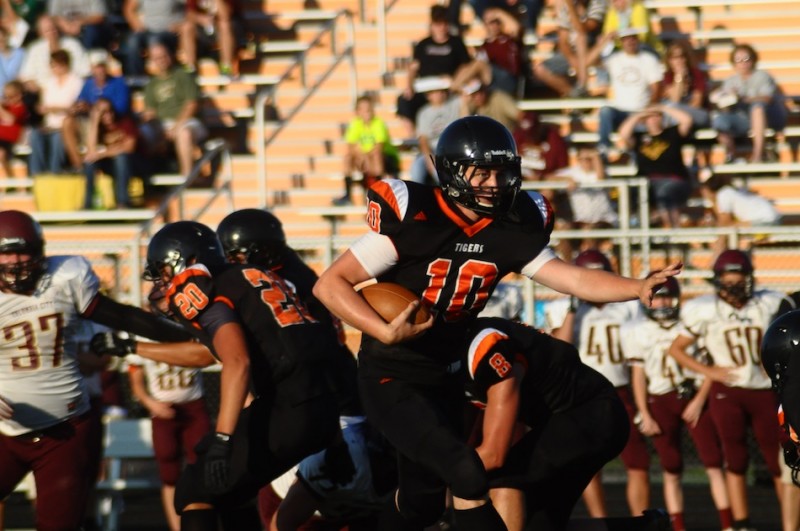 Warsaw quarterback Austin Head looks for room to run Friday night. The Tigers opened the 2013 season by defeating Columbia City 33-14 (Photo by Amanda Farrell)