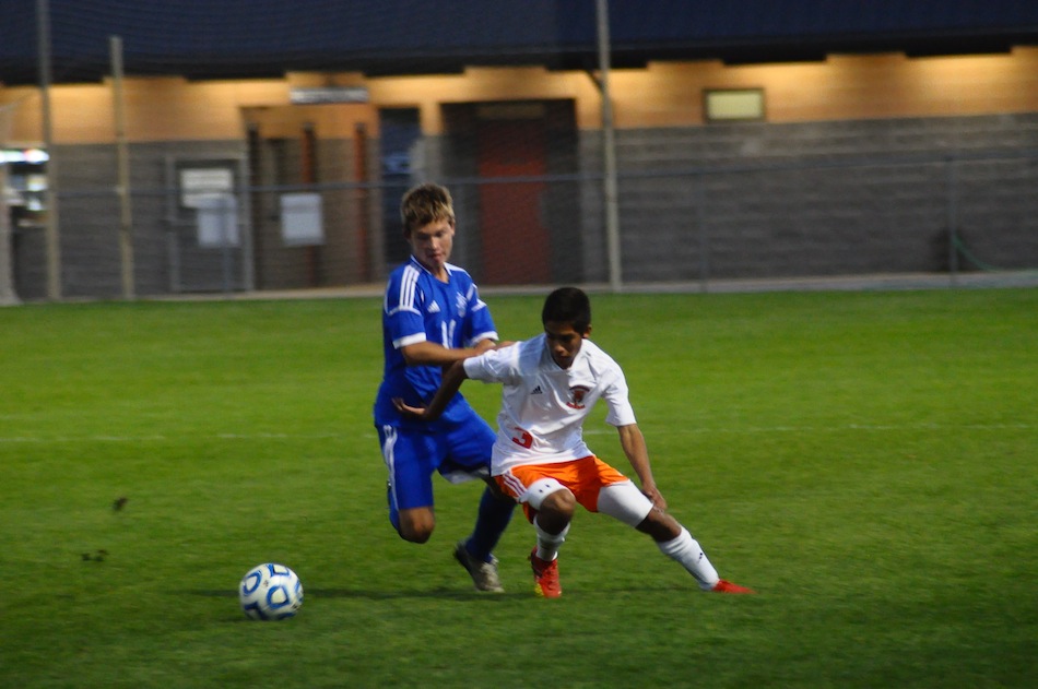 Romeo Rosales of Warsaw holds off Canterbury's Logan Scheiber Tuesday night. The No. 6 Tigers topped the No. 15 Cavaliers 3-2 (Photos by Amanda Farrell)