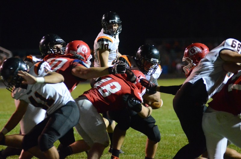 Tristan McClone of Warsaw blasts into Goshen's John Trenshaw Friday night.  McClone ran for 244 yards and three touchdowns in a 34-13 Tiger win (Photos by Scott Davidson)