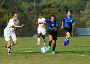 Whitko's Ellyana Blue makes a push for a loose ball as Wawasee's Zoe Abrams closes in.