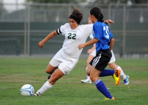 Wawasee midfielder Caitlin Clevenger loads up for a shot attempt while Whitko's Abby Overmyer defends.