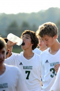 Andrew Matthews of Wawasee gets a drink in before the match. Temps at game time were hovering near 90 degrees.