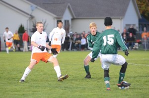 Sam Allbritten steps in to defend for Warsaw as Elliott Laughlin looks to pass the ball for Northridge.