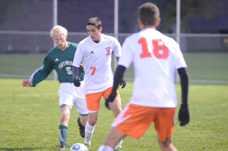 Warsaw's Zack Tucker controls the ball as Micah Miller of Northridge defends Saturday night. The No. 9 Tigers shutout the Raiders 1-0 in the regional finale at Mishawaka (Photos by Scott Davidson)