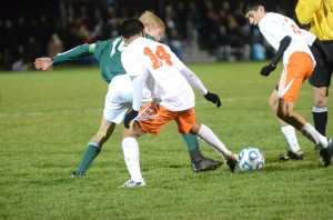 Miguel Rivera (No. 14) of Warsaw tries to take the ball from Steven Hooley of Northridge. At right is Tito Cuellar, who scored the game winner for the Tigers.