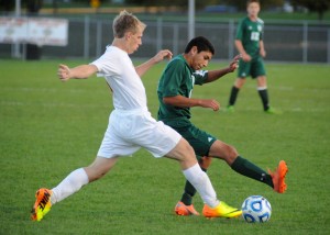 Wawasee's Harvey Lopez tries to hold off Plymouth's Kameron Ray.