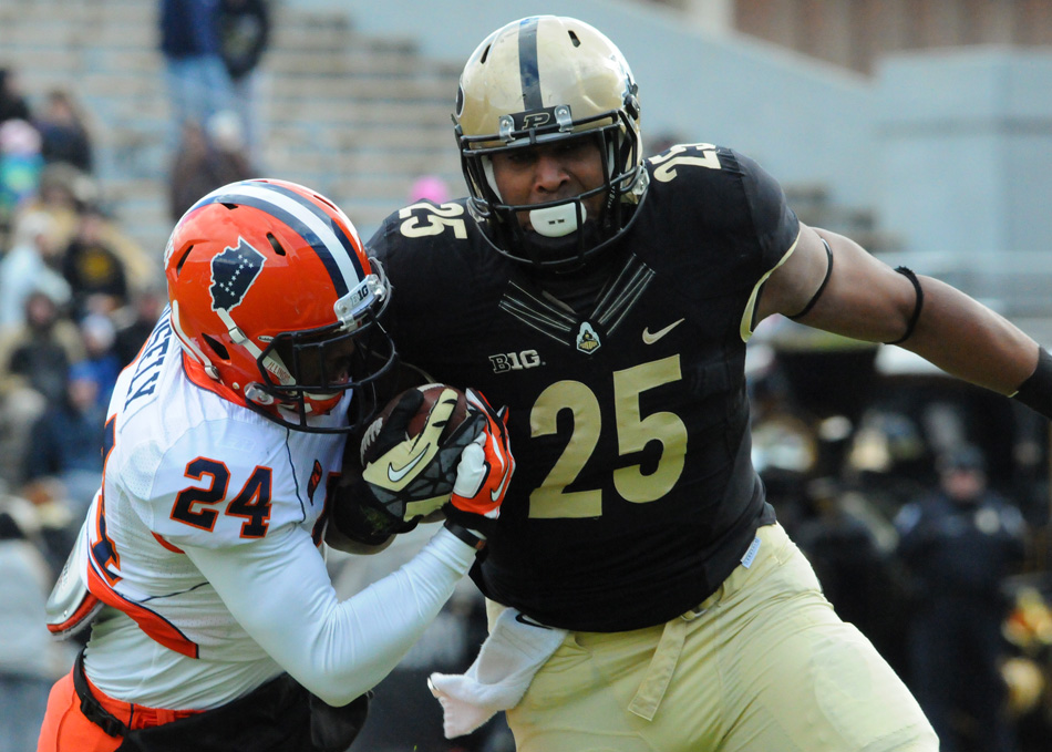 Purdue running back Brandon Cottom looks to shed the tackle of Illinois defensive back Darius Mosley Saturday afternoon. The Illini held on to beat the Boilermakers 20-16. (Photos by Dave Deak)