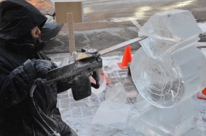 A sculptor works to finish his creation prior to the 2013 Fire and Ice First Friday.  (Photo by Alyssa Richardson)