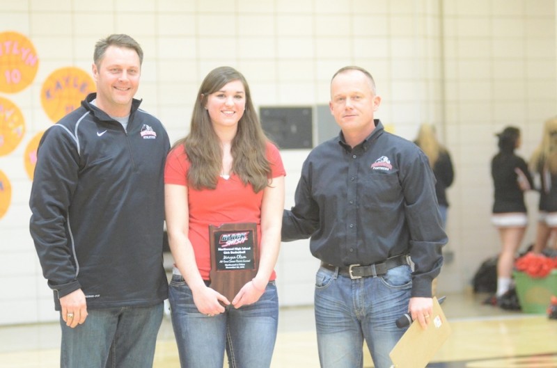 NorthWood senior Morgan Olson was honored recently for being the school's all-time leading scorer for girls basketball. Olson is show above with (from left) NorthWood principal David Maugel and NorthWood athletic director Norm Sellers.