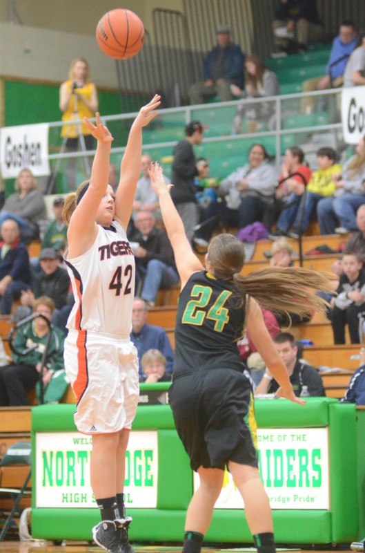 Senior Nikki Grose lets fly with a long jumper for the Tigers. Grose scored 13 points in her final high school game.