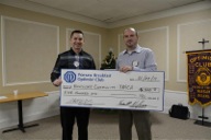 (From left) Chad Zaucha accepting the check for $500 from Adam Turner, representing the Optimists. (Photo provided)