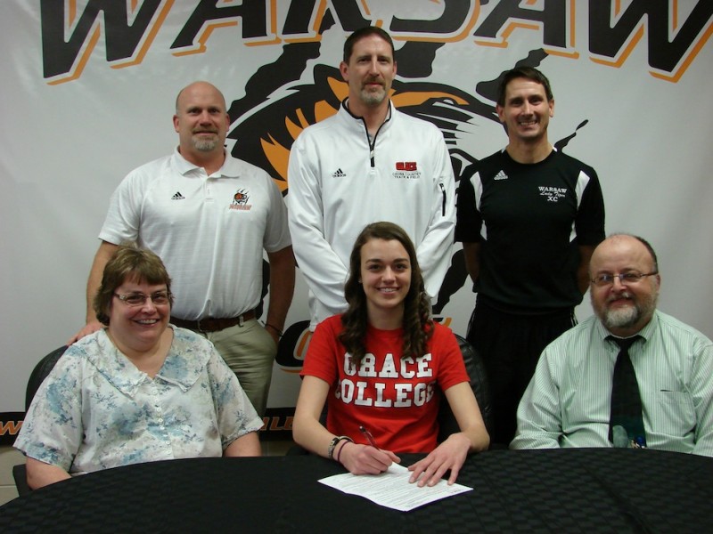 WCHS senior Aletheia Burritt will compete in cross country and track at Grace College. Burritt is shown above with her parents Tami and Mark. In back are WCHS Athletic Director Dave Anson, Grace College cross country and track  coach Jeff Raymond and WCHS girls cross country and track coach Scott Erba (Photo provided) 