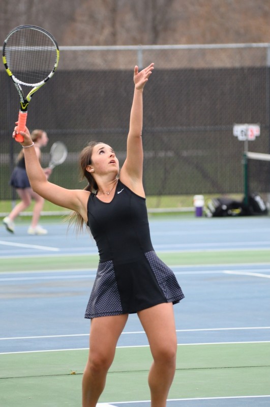 Senior Jacqueline Sasso prepares to serve for Warsaw Thursday.