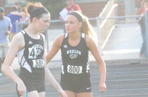 Ann Harvuot (left) and Mariah Harter chat after placing first and third in the 100.