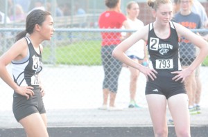 Anna Craig (left) and Hannah Dawson rest after placing 2-3 in the 800 for Warsaw.