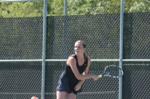 Anna Hall follows her serve for Warsaw in doubles action.