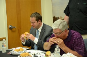 David Hoffert and Joe Thallemer enjoy burgers together as they work to determine which of the top four burgers has their votes.  (Photo by Alyssa Richardson)