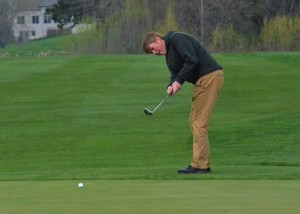 Brandon Buss putts onto No. 18.