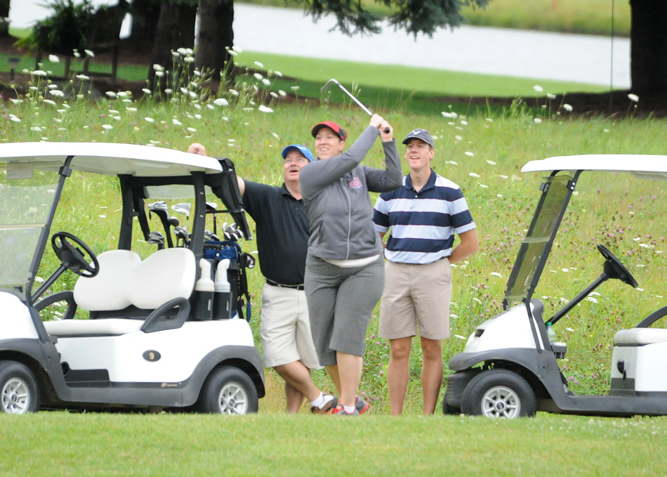 Grace College volleyball head coach Andria Harshman follows through on her approach to the ninth green during the Grace College Golf Outing at Stonehenge Monday morning. (Photo by Mike Deak)