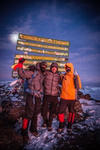 John Burkett, Mark Nolan and Tommy Danger stand at the peak of Mt. Kilimanjaro in Tanzania after reaching the summit of the first of seven mountains.