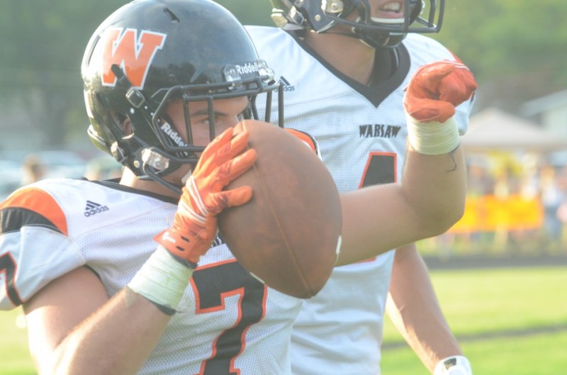 Ethyn Bradley makes his point after a touchdown run for Warsaw.