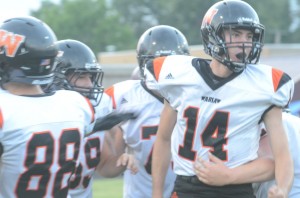 Jake Mangas celebrates with his Tiger teammates after tossing a touchdown pass Friday night.