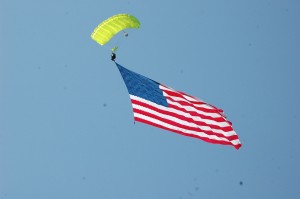 Andy Crout-Hammel descends with a 2,500 square foot American Flag to the peninsula on Venetian Island, Lake Wawasee. (Photo by Ollievia Sigsbee)