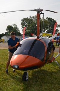 SLEEK AND BEAUTIFUL— Dan Saunders polishes a factory-assembled gyrocraft that he was offering for sale during last week’s Popular Rotorcraft Association convention in Mentone. (Photo by Keith Knepp)