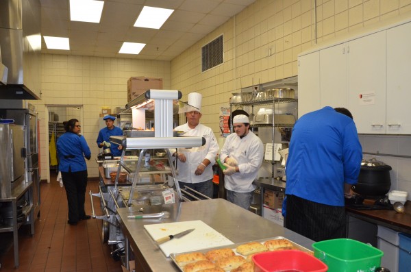 Students in the WACC Blue Apron culinary arts program work to prepare food orders from their first customers of a soft-opening held yesterday.  (Photo by Alyssa Richardson)