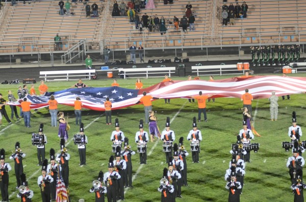 A huge American flag is unfurled Friday night as the Warsaw band plays the National Anthem at the home football game (Photo by Scott Davidson)