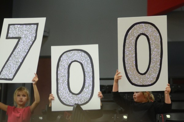 Grace College men's basketball coach Jim Kessler is saluted Friday night by his loving granddaughters. Kessler won his 700th game at Grace.