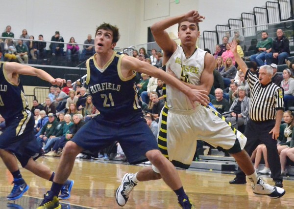 Brock Goeglein (left) tries to box out Stori Bright after a Wawasee free throw attempt.