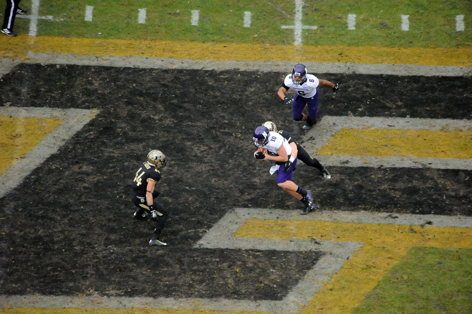 Northwestern quarterback Zack Oliver maneuvers against Purdue.