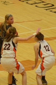 Kylee Rostochak of Wawasee is bottled up by a pair of Warsaw defenders.