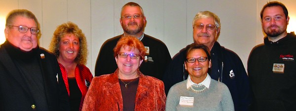 Back, L to R: IBA State President Tom Mullen, Indiana District 22 State Representative  Rebecca Kubacki, BAKFC Board President Brett Harter, Larry Coplen and David Johnson. Front, L to R: Executive Officer Joni Truex and IBA Chief Operating Officer Cindy Bussel.